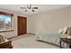 Bright bedroom with window, ceiling fan, double closet, and carpeted floor providing a cozy and inviting atmosphere at 3973 S Joplin Way, Aurora, CO 80013