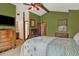 Spacious bedroom with vaulted ceiling, four-poster bed, an ensuite bath, natural light, and neutral carpet flooring at 3973 S Joplin Way, Aurora, CO 80013