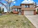 Charming two-story home with a two-car garage and a well-manicured front yard at 3973 S Joplin Way, Aurora, CO 80013