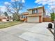 Beautiful two-story home with a spacious driveway and a well-maintained lawn at 3973 S Joplin Way, Aurora, CO 80013