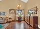 Living room featuring hardwood floors, an ornate buffet cabinet, and bright window for natural light at 3973 S Joplin Way, Aurora, CO 80013