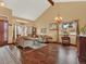 Bright living room with high ceilings, hardwood floors, and an ornate buffet cabinet at 3973 S Joplin Way, Aurora, CO 80013