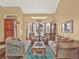 Inviting living room with sofas, accent chairs, and a beautiful bay window offering abundant natural light at 3973 S Joplin Way, Aurora, CO 80013