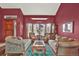 Formal living room with decorative sofas, large bay window, area rug, and wooden entry door at 3973 S Joplin Way, Aurora, CO 80013