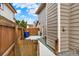 View of the side yard with wooden fence, exterior siding, and a concrete walkway at 3973 S Joplin Way, Aurora, CO 80013