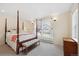 Primary bedroom with a four poster bed, bench, and a large window for ample natural light at 45 Bridge St, Breckenridge, CO 80424