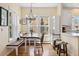 Bright dining nook with a built-in bench, a large table, and a view of the neighborhood at 45 Bridge St, Breckenridge, CO 80424