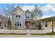 Inviting home featuring a covered front porch, complemented by a white picket fence and mature trees at 45 Bridge St, Breckenridge, CO 80424