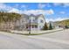 Stylish home showcasing a well-manicured lawn, mature trees, and a charming covered front porch at 45 Bridge St, Breckenridge, CO 80424