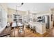 Open kitchen concept with a dining area, natural wood floors, and stainless steel appliances at 45 Bridge St, Breckenridge, CO 80424