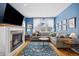 Spacious living room with a fireplace, comfortable seating, and ample natural light for relaxation and entertainment at 45 Bridge St, Breckenridge, CO 80424