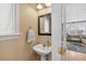Cozy powder room featuring a pedestal sink and a glimpse into the living area at 45 Bridge St, Breckenridge, CO 80424