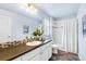 Bathroom with modern vanity, large mirror, and a combined shower and tub with updated fixtures at 14284 W 88Th Dr # B, Arvada, CO 80005