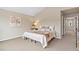 Neutral bedroom featuring soft carpet, a comfortable bed, and a serene decor at 14284 W 88Th Dr # B, Arvada, CO 80005