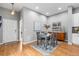 Inviting dining room with hardwood floors, table for four, and adjacent kitchen area at 14284 W 88Th Dr # B, Arvada, CO 80005