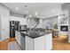 Spacious kitchen island with black countertop, stainless steel appliances, and adjacent fireplace at 14284 W 88Th Dr # B, Arvada, CO 80005