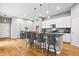 Modern kitchen featuring an island with bar seating, white cabinets, and stainless steel appliances at 14284 W 88Th Dr # B, Arvada, CO 80005