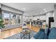 Open-concept living room featuring hardwood floors, large windows, and modern decor at 14284 W 88Th Dr # B, Arvada, CO 80005
