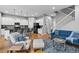 Open concept living space with hardwood floors, modern kitchen, and comfortable seating area at 14284 W 88Th Dr # B, Arvada, CO 80005