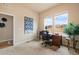 Well-lit home office with carpet flooring, a wooden desk, and views of the neighborhood at 14284 W 88Th Dr # B, Arvada, CO 80005