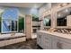 Luxurious bathroom with garden tub, dual sink vanity and mountain mural backdrop at 8370 Midsummer Ln, Elizabeth, CO 80107