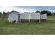 Chicken coop with fenced pen on a grassy lot with mature trees in the background on an overcast day at 8370 Midsummer Ln, Elizabeth, CO 80107