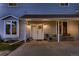 Close-up of the double-door entry with cozy seating, enhanced by warm lighting and a welcoming ambiance at 8370 Midsummer Ln, Elizabeth, CO 80107