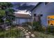 Charming backyard garden featuring stone paths, raised garden beds, and lush plants near the house at 8370 Midsummer Ln, Elizabeth, CO 80107
