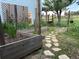 View of wooden garden beds with stone walkway leading to a gate in a fenced yard on a sunny day at 8370 Midsummer Ln, Elizabeth, CO 80107