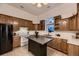 Charming kitchen featuring wood cabinetry, white appliances, and a functional center island at 8370 Midsummer Ln, Elizabeth, CO 80107