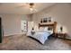 Spacious main bedroom featuring plush carpeting and a view of laundry area at 8370 Midsummer Ln, Elizabeth, CO 80107