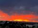 Beautiful sunset view with vibrant colors over a mountain range and the city at 8370 Midsummer Ln, Elizabeth, CO 80107