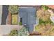 Birds-eye view of a well-maintained house with a dark roof, landscaped yard, and stone walkways at 2320 S Valley Hwy, Denver, CO 80222