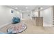Basement area featuring a wet bar, plush furniture, and neutral carpeting at 2320 S Valley Hwy, Denver, CO 80222