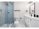 Bathroom features tiled shower with glass door, modern vanity, and fixtures at 2320 S Valley Hwy, Denver, CO 80222