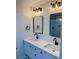 Bathroom featuring double vanity, black fixtures, modern light fixtures, and framed mirrors at 2320 S Valley Hwy, Denver, CO 80222