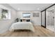 Cozy bedroom featuring a full bed, natural light and bathroom with modern sliding door at 2320 S Valley Hwy, Denver, CO 80222