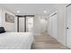 Bright bedroom features wood floors, barn door to bathroom, and closet with sliding doors at 2320 S Valley Hwy, Denver, CO 80222