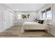 Sunlit bedroom boasts a plush bed, bay window, and convenient closet space at 2320 S Valley Hwy, Denver, CO 80222