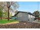 Exterior view of a gray painted brick home with a well-maintained yard at 2320 S Valley Hwy, Denver, CO 80222
