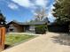 Ranch-style home featuring an attached garage, a covered entrance and low maintenance landscaping at 2320 S Valley Hwy, Denver, CO 80222