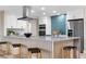Modern kitchen with a stylish island, stainless steel appliances, and a tile backsplash at 2320 S Valley Hwy, Denver, CO 80222