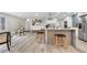 Bright, modern kitchen featuring a large island, stainless steel appliances, and an open layout at 2320 S Valley Hwy, Denver, CO 80222