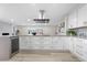 Spacious kitchen with an eat-in bar, quartz countertops, stainless steel appliances, and modern recessed lighting at 2320 S Valley Hwy, Denver, CO 80222