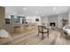 Open-concept living room and kitchen with modern decor, a fireplace, and hardwood floors at 2320 S Valley Hwy, Denver, CO 80222