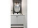 Stylish powder room with modern vanity, decorative mirror, chic lighting, and attractive finishes at 2320 S Valley Hwy, Denver, CO 80222