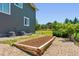 Backyard garden with rock surround and wood raised garden bed at 42350 Forest Oaks Dr, Elizabeth, CO 80107