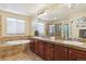Well-appointed bathroom featuring double vanities, separate tub, and shower at 42350 Forest Oaks Dr, Elizabeth, CO 80107