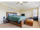 Comfortable bedroom with a king bed, wood accents and a small seating area at 42350 Forest Oaks Dr, Elizabeth, CO 80107