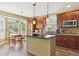 Beautiful kitchen with stainless steel appliances, central island, and adjacent breakfast nook at 42350 Forest Oaks Dr, Elizabeth, CO 80107